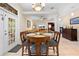 Dining room with tiled flooring, decorative columns, and an open layout to the living area at 4180 Jacaranda Cir, Brooksville, FL 34604