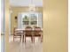 Bright dining area with a chandelier, window with shutters, and charming decor at 4180 Jacaranda Cir, Brooksville, FL 34604