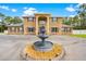 Stunning two-story home featuring a circular driveway with a water fountain and manicured landscaping at 4180 Jacaranda Cir, Brooksville, FL 34604