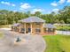 Elegant two-story home featuring decorative columns and a circular driveway with a charming water fountain at 4180 Jacaranda Cir, Brooksville, FL 34604