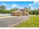 Stunning two-story home featuring a side-entry garage and a circular driveway with a beautiful water fountain at 4180 Jacaranda Cir, Brooksville, FL 34604
