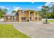 Beautiful two-story home featuring classic architectural details, manicured lawns, and a circular driveway at 4180 Jacaranda Cir, Brooksville, FL 34604