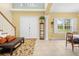 Welcoming foyer with double doors, tile flooring, a staircase, and a display cabinet at 4180 Jacaranda Cir, Brooksville, FL 34604