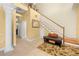 Spacious foyer featuring a staircase, decorative column, and a cozy seating area at 4180 Jacaranda Cir, Brooksville, FL 34604