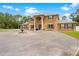 Grand two-story home with a circular driveway and charming water fountain feature at entrance at 4180 Jacaranda Cir, Brooksville, FL 34604