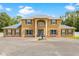 Elegant two-story home with striking columns, blue shutters, and a beautiful water fountain feature at 4180 Jacaranda Cir, Brooksville, FL 34604