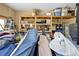 A cluttered garage showcasing storage shelves filled with household items, and various assorted belongings at 4180 Jacaranda Cir, Brooksville, FL 34604