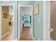 Hallway featuring doorways to bedrooms, wood floors and decorations at 4180 Jacaranda Cir, Brooksville, FL 34604