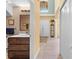 Inviting hallway leads past a modern bathroom with a dark wood vanity at 4180 Jacaranda Cir, Brooksville, FL 34604