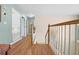 Bright hallway featuring wood floors and staircase with decorative spindles leading to the upper level at 4180 Jacaranda Cir, Brooksville, FL 34604
