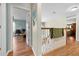 Hallway showcasing hardwood floors, staircase, and neutral paint colors at 4180 Jacaranda Cir, Brooksville, FL 34604