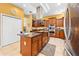 A kitchen with a center island, stainless appliances, a range hood, and tile floors at 4180 Jacaranda Cir, Brooksville, FL 34604