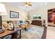 Comfortable living room featuring a decorative coffee table, plush sofa, and decorative lamps at 4180 Jacaranda Cir, Brooksville, FL 34604