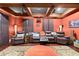 Relaxing movie room featuring comfortable leather recliners, ceiling fans, and a projector setup at 4180 Jacaranda Cir, Brooksville, FL 34604