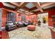 Comfortable movie room featuring a projector screen, plush seating, and warm, inviting colors at 4180 Jacaranda Cir, Brooksville, FL 34604