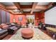 Movie room with an impressive projector screen, leather couches, and unique ceiling design at 4180 Jacaranda Cir, Brooksville, FL 34604