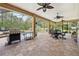 Relax on this screened patio, complete with outdoor grill and overlooks a backyard swimming pool at 4180 Jacaranda Cir, Brooksville, FL 34604