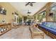 The spacious patio with ceiling fans provides an inviting space to relax, with picturesque views of the pool and garden at 4180 Jacaranda Cir, Brooksville, FL 34604