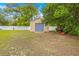 Exterior of a backyard shed with a blue garage door, providing extra storage space at 4180 Jacaranda Cir, Brooksville, FL 34604