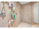Tiled shower featuring shower caddy with multiple bottles and cleaning supplies at 4180 Jacaranda Cir, Brooksville, FL 34604