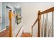 Staircase featuring wood and white rails, leading to multiple rooms upstairs at 4180 Jacaranda Cir, Brooksville, FL 34604