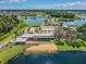 Aerial view of community lakefront recreation center with beach and ample parking at 4275 Burdick Loop, Odessa, FL 33556