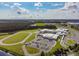 An aerial view of a school, sporting fields, parking, and surrounding green spaces at 4275 Burdick Loop, Odessa, FL 33556