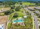 An aerial view showcases a community pool, recreation areas, and playgrounds at 4275 Burdick Loop, Odessa, FL 33556