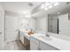 Bright bathroom features double sink vanity, ample lighting, and tile floor and shower at 4275 Burdick Loop, Odessa, FL 33556