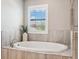 Bathroom featuring an oval tub with a large window with shutters for natural light at 4275 Burdick Loop, Odessa, FL 33556