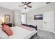 Comfortable bedroom with soft carpet, ceiling fan, and beach-themed decor at 4275 Burdick Loop, Odessa, FL 33556