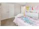 Bright bedroom with a bed, and a dresser with princess themed artwork at 4275 Burdick Loop, Odessa, FL 33556