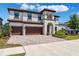 Mediterranean style home featuring a barrel tile roof, three car garage and neutral color palette at 4275 Burdick Loop, Odessa, FL 33556