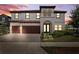 Beautiful two-story home boasts a 3-car garage and lush landscaping, captured at twilight at 4275 Burdick Loop, Odessa, FL 33556