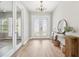 Bright foyer with wood floors, a modern chandelier, and elegant decor at 4275 Burdick Loop, Odessa, FL 33556