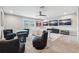 Spacious game room with plush carpet, gaming console, ceiling fan, and beach views on three TVs at 4275 Burdick Loop, Odessa, FL 33556