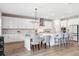 Elegant kitchen featuring ample white cabinetry, an island with bar seating, and stainless steel appliances at 4275 Burdick Loop, Odessa, FL 33556