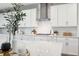 Close-up shot of the modern kitchen with white cabinets, quartz countertops, and stainless steel appliances at 4275 Burdick Loop, Odessa, FL 33556
