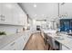 Stylish kitchen featuring white cabinets, stainless steel appliances, a subway tile backsplash, and a large center island at 4275 Burdick Loop, Odessa, FL 33556