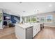 Open-concept kitchen with a large island, stainless steel appliances, and a view to the living area and backyard at 4275 Burdick Loop, Odessa, FL 33556