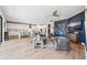 Open-concept living space featuring a kitchen with a large island and seating, connected to a living room with modern decor at 4275 Burdick Loop, Odessa, FL 33556