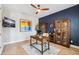 Well-appointed home office featuring a desk, ceiling fan, and ample natural light at 4275 Burdick Loop, Odessa, FL 33556