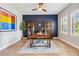 Stylish home office with built-in cabinets, a large desk, and a ceiling fan at 4275 Burdick Loop, Odessa, FL 33556