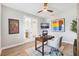 Comfortable home office featuring a desk, ceiling fan, and plenty of natural light at 4275 Burdick Loop, Odessa, FL 33556