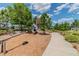 A community playground features a seesaw, slide and nearby walking path at 4275 Burdick Loop, Odessa, FL 33556