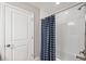 Modern shower features white tile surround, a shower rod, and a blue and white shower curtain at 4275 Burdick Loop, Odessa, FL 33556