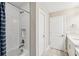 Modern shower features white tile surround, built-in niche, and a blue and white shower curtain at 4275 Burdick Loop, Odessa, FL 33556