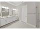 Modern bathroom with dual sinks, granite countertops, and a sleek glass-enclosed shower at 4300 Barletta Ct, Wesley Chapel, FL 33543