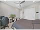 Cozy bedroom features a ceiling fan and a large bed, with closet and TV at 4300 Barletta Ct, Wesley Chapel, FL 33543