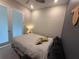 Comfortable bedroom with sleeper sofa, gray walls, recessed lighting, and frosted glass doors at 4300 Barletta Ct, Wesley Chapel, FL 33543